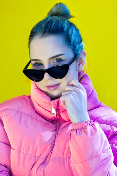 A pink zipper jacket, wearing dark sunglasses woman
